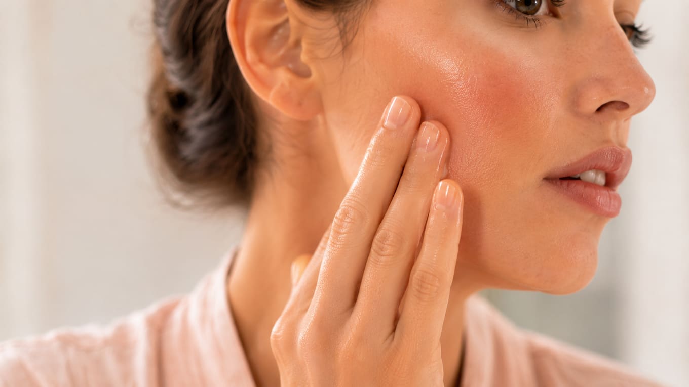 Patting serum into a freshly dermaplaned cheek
